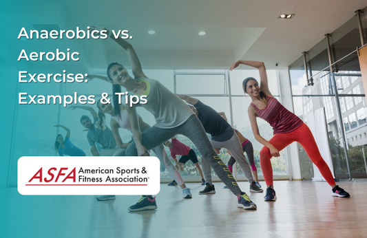 A group fitness class with people performing aerobic exercises in a well-lit indoor studio.