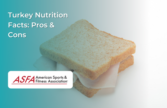 A simple turkey sandwich made with wheat bread and deli turkey slices on a light background.