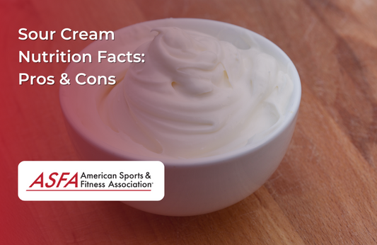A bowl of creamy sour cream placed on a wooden surface.