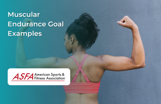 A woman in a pink sports bra flexes both arms in front of a plain wall.