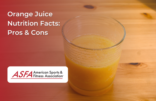 A glass of orange juice sitting on a wooden table