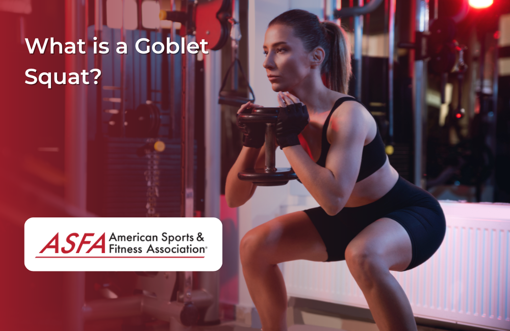 A woman in black workout attire performs a goblet squat in a gym while holding a dumbbell.