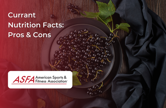 A dark plate with black currants arranged on a textured dark fabric background.