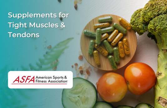 A wooden bowl of green and orange capsules sits next to broccoli, tomatoes, cucumber slices, and pink salt.