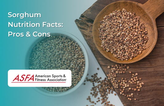 A wooden spoon filled with sorghum grains, with more grains scattered around.