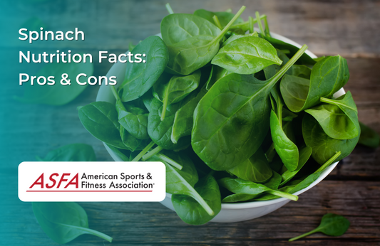 A fresh bowl of green spinach leaves sitting on a rustic wooden table.