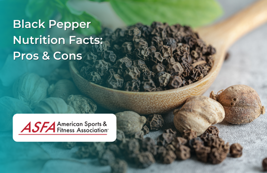 A wooden spoon filled with black peppercorns, surrounded by whole dried pepper fruits.
