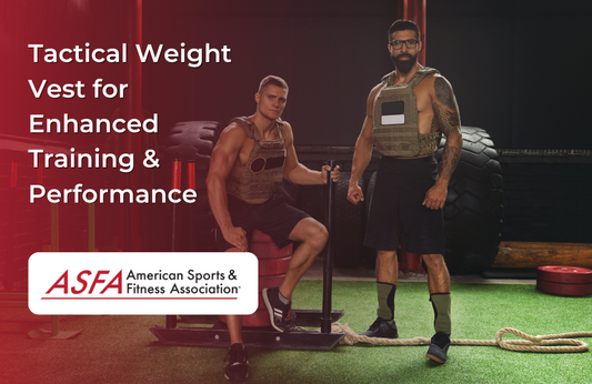 Two men wearing tactical weight vests pose in a gym beside large tires and sled equipment.