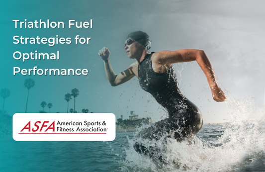 A female athlete in a wetsuit running out of the ocean with water splashing around her.