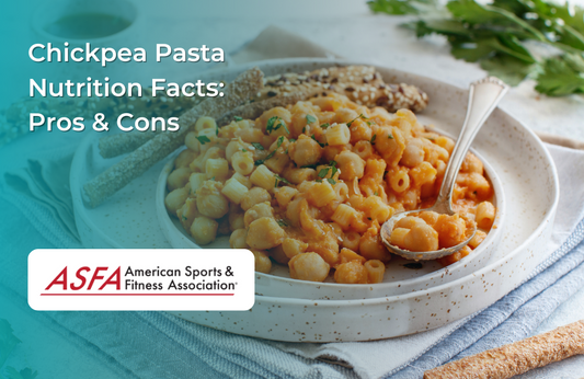 A bowl of chickpea pasta with a creamy sauce, garnished with parsley, with a spoon resting on the plate.