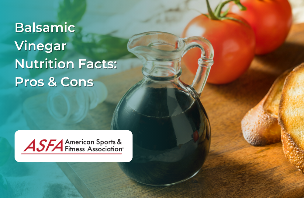 A glass bottle of balsamic vinegar on a wooden table with tomatoes.