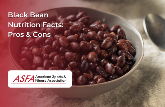 A bowl filled with cooked black beans with a rustic background.