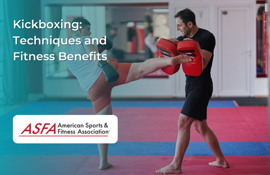 Kickboxing training session with a man holding pads and a woman delivering a kick.