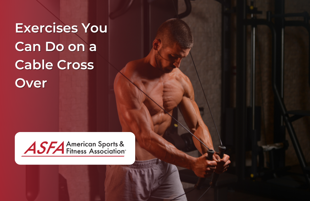 A shirtless man using a cable crossover machine in a dimly lit gym.