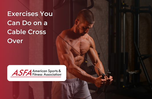 A shirtless man using a cable crossover machine in a dimly lit gym.