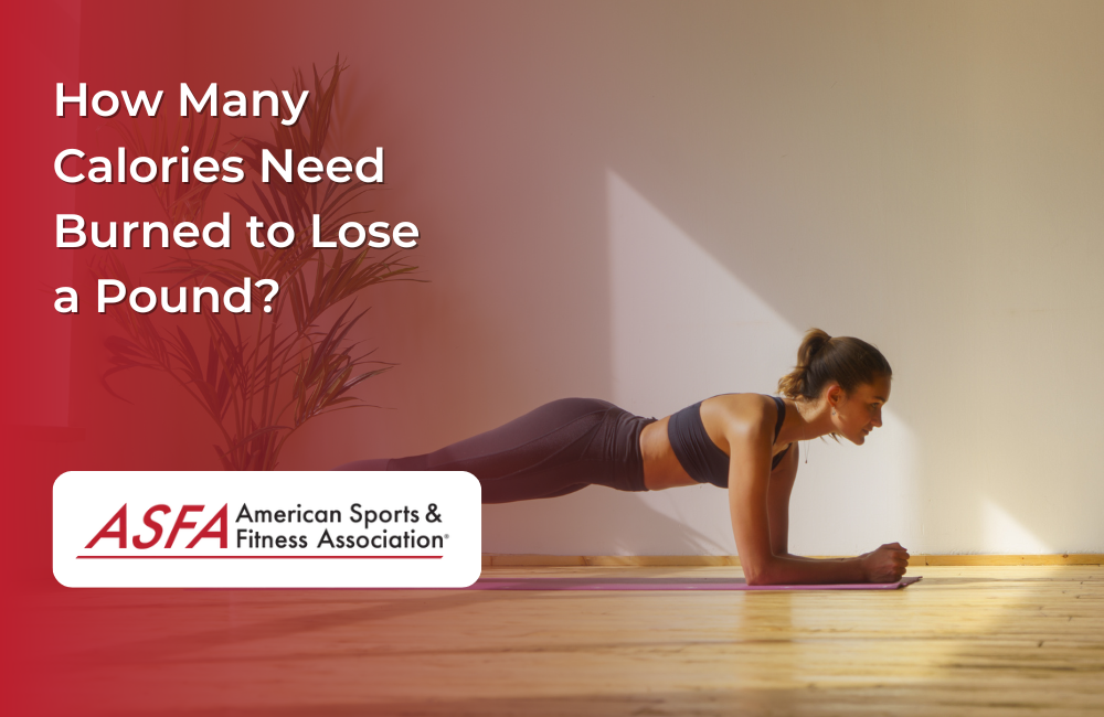 Lady in black workout clothing performing a plank inside on a wooden floor.