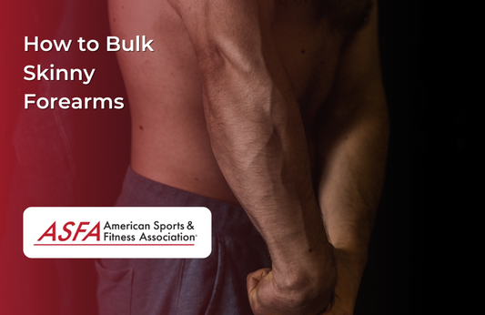 A close-up of a man’s muscular forearm as he clenches a weight in the gym, showing strong arm definition.