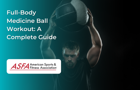A man in a dark gym lifting a medicine ball overhead.