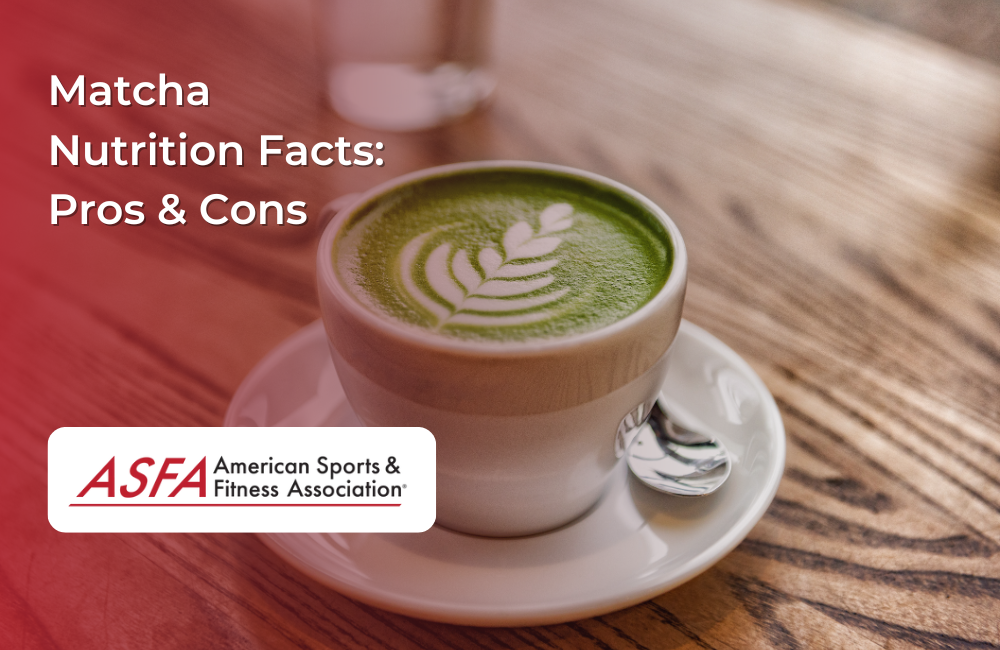 A cup of matcha latte with foam art on a wooden table.