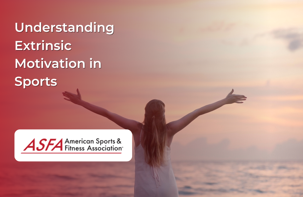 A woman with outstretched arms facing the ocean during a colorful sunrise or sunset. 