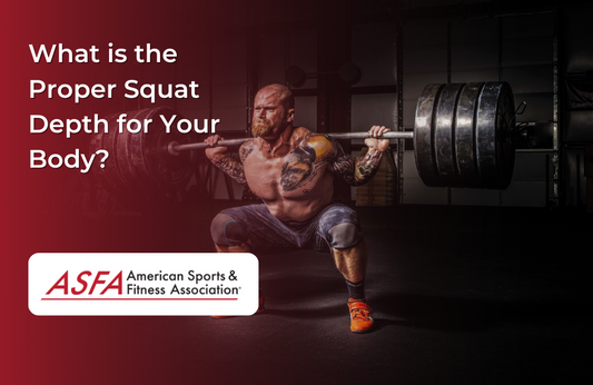 A heavily tattooed man performing a deep squat with a loaded barbell in a gym.