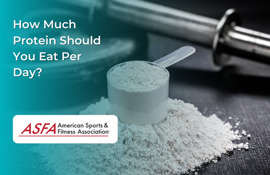 Protein powder in a scoop in from of a barbell.