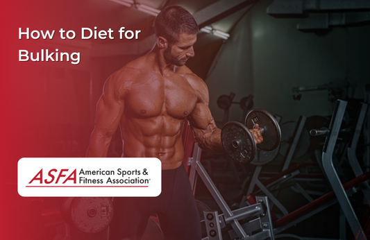 A muscular man with a beard lifting dumbbells in a gym, shirtless.