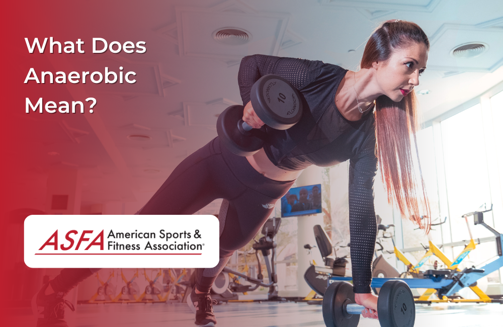 Lady in black workout clothes planking a lifting dumbbells at a gym.