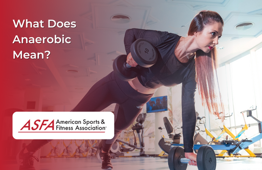 Lady in black workout clothes planking a lifting dumbbells at a gym.