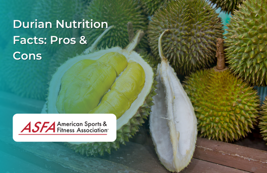 Whole and cut durian fruit displayed on a wooden table.