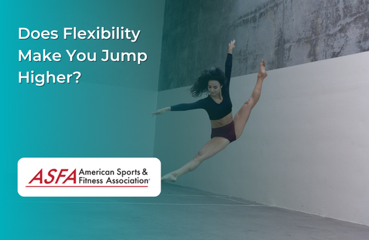 A woman in black workout gear jumping in a dance studio. 