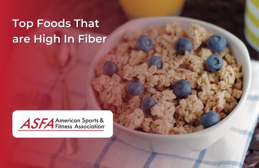 A bowl of oatmeal with blueberries, placed on a white and blue placemat with a spoon next to it.  