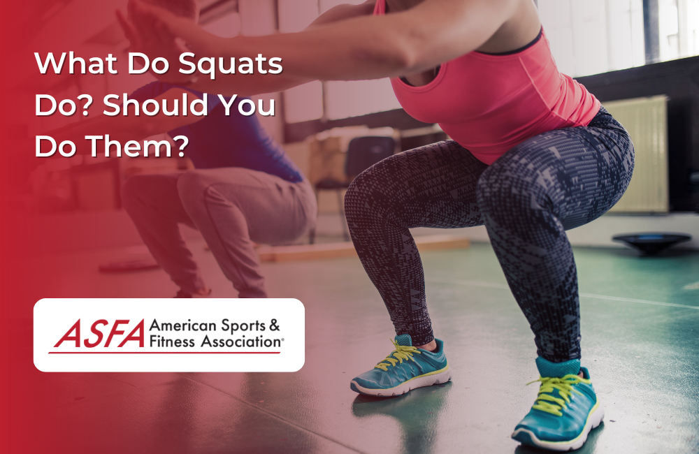 Two people doing squats next to each other inside. 