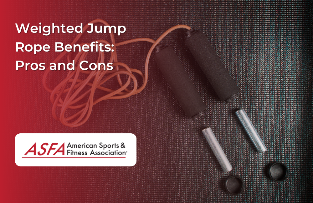 Weighted jump rope laying on a black mat.