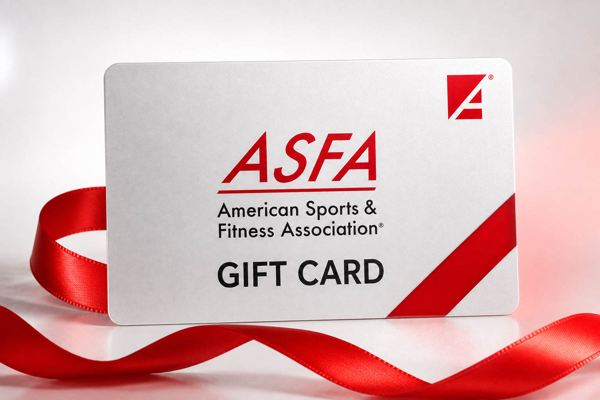 A white American Sports & Fitness Association gift card with red and black text, featuring a red ribbon loop and a red diagonal stripe, photographed on a light gray background.