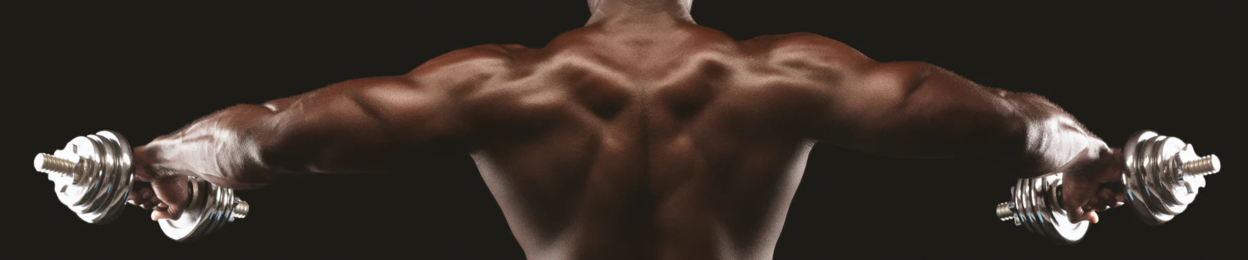 African american man with dumbbells performing a lateral raise