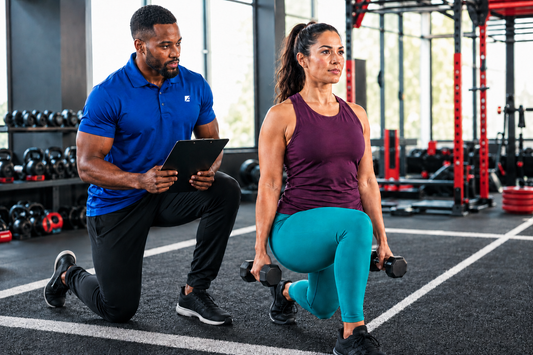 ASFA weight loss coach training a client who is performing a lunge in a gym.